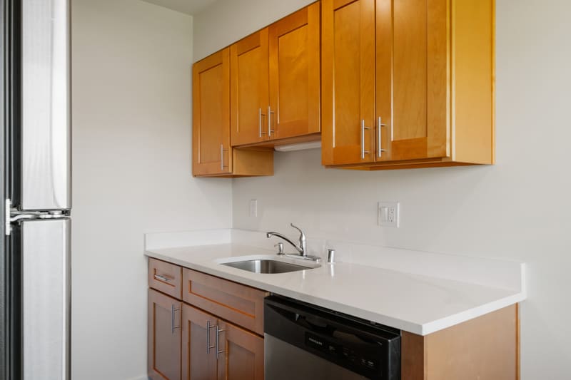 Renovated living area with new plank flooring at Campus Village